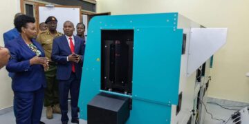 Interior CS Kithure Kindiki inspects a new passport printing machine.