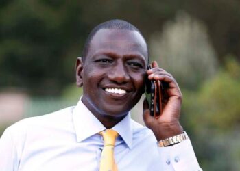 A handout picture taken and released on April 5, 2016 by the Deputy President's Press Office shows Kenya's Deputy President William Ruto using his phone shortly after charges of crimes against humanity against him were dropped, at his office in Karen district in Nairobi. War crimes judges today dropped charges of crimes against humanity against Kenya's Deputy President William Ruto over his alleged role in 2007-2008 post-election turmoil, but left open the possibility of a fresh trial. In what will be a fresh blow to the prosecution, the judges at the International Criminal Court (ICC) ruled the charges against Ruto and his co-accused Joshua arap Sang "are vacated." / AFP PHOTO / Deputy President Press Office / Charles Kimani / RESTRICTED TO EDITORIAL USE - MANDATORY CREDIT "AFP PHOTO / DEPUTY PRESIDENT PRESS OFFICE / CHARLES KIMANI" - NO MARKETING NO ADVERTISING CAMPAIGNS - DISTRIBUTED AS A SERVICE TO CLIENTS