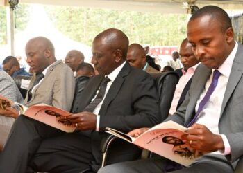 MP John Kiarie (R) sits next to President Ruto during the funeral ceremony of the MP's father. PHOTO/ Kiarie