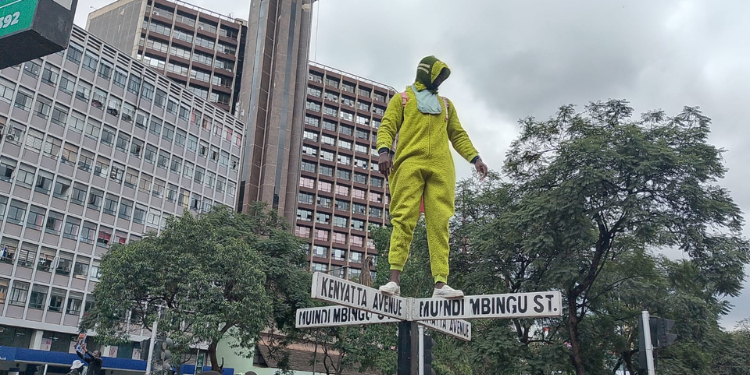 Man on top of Kenyatta Avenue Street post. Photo/TKT
