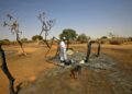 AFP | After years of conflict, clashes still erupt in the Darfur region; a man checks the aftermath of violence in the village of Twail Saadoun, the capital of South Darfur, in February 2021