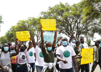 Activists hold placards during a climate change protest in Kenya |  James Wakibia/SOPA Images/LightRocket via Getty Images