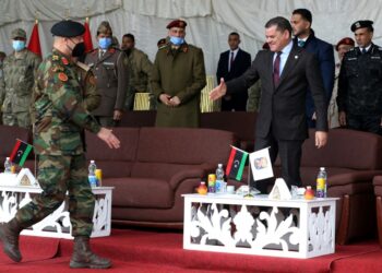 Libyan interim Prime Minister Abdulhamid Dbeibah (R) greets Lieutenant General Mohammad Ali al-Haddad (L), chief of the general staff of the Libyan army, during a military graduation ceremony in the capital Tripoli on January 23, 2022 | AFP