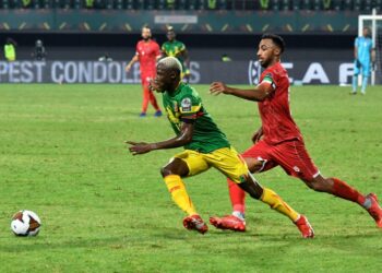 Mali winger Moussa Djenepo (L) is pursued by Equatorial Guinea captain and defender Carlos Akapo during an Africa Cup of Nations last-16 match in Limbe on Wednesday | AFP
