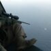 This undated handout photo released by South Korea's military on May 4, 2009 shows South Korean soldiers aboard a helicopter aiming a sniper rifle at a pirate boat after repelling its attack on a North Korean ship in waters off Somalia | AFP