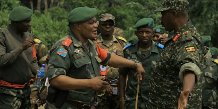 Congolese General Camille Bombele, left, and Ugandan Major General Kayanja Muhanga, at a camp in Semulki last December | AFP