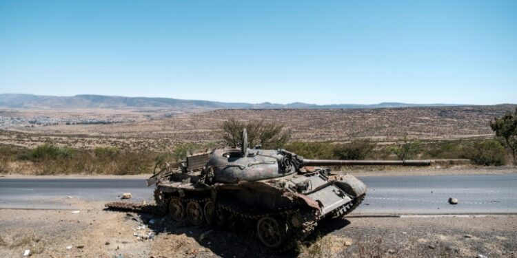 A damaged tank stands on a road north of Mekele, the capital of Tigray, in early 2021 | AFP