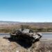 A damaged tank stands on a road north of Mekele, the capital of Tigray, in early 2021 | AFP