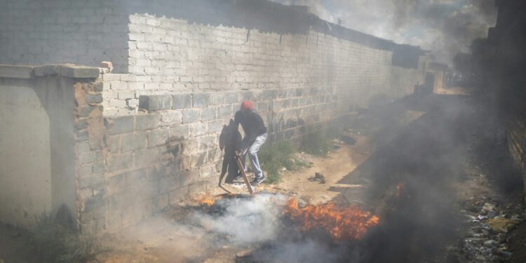 Residents of Diepsloot, a township of Johannesburg, burned tyres in a protest last Wednesday against rising crime | AFP