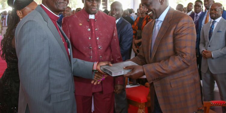 President William Ruto is gifted a bible by the clergy during a prayer service in Nakuru.Photo/PCS