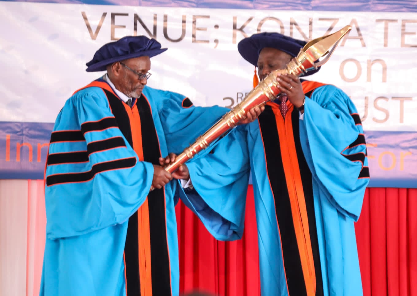 Open University Chancellor James Mwangi (Right) receiving the instrument of power after his appointment.