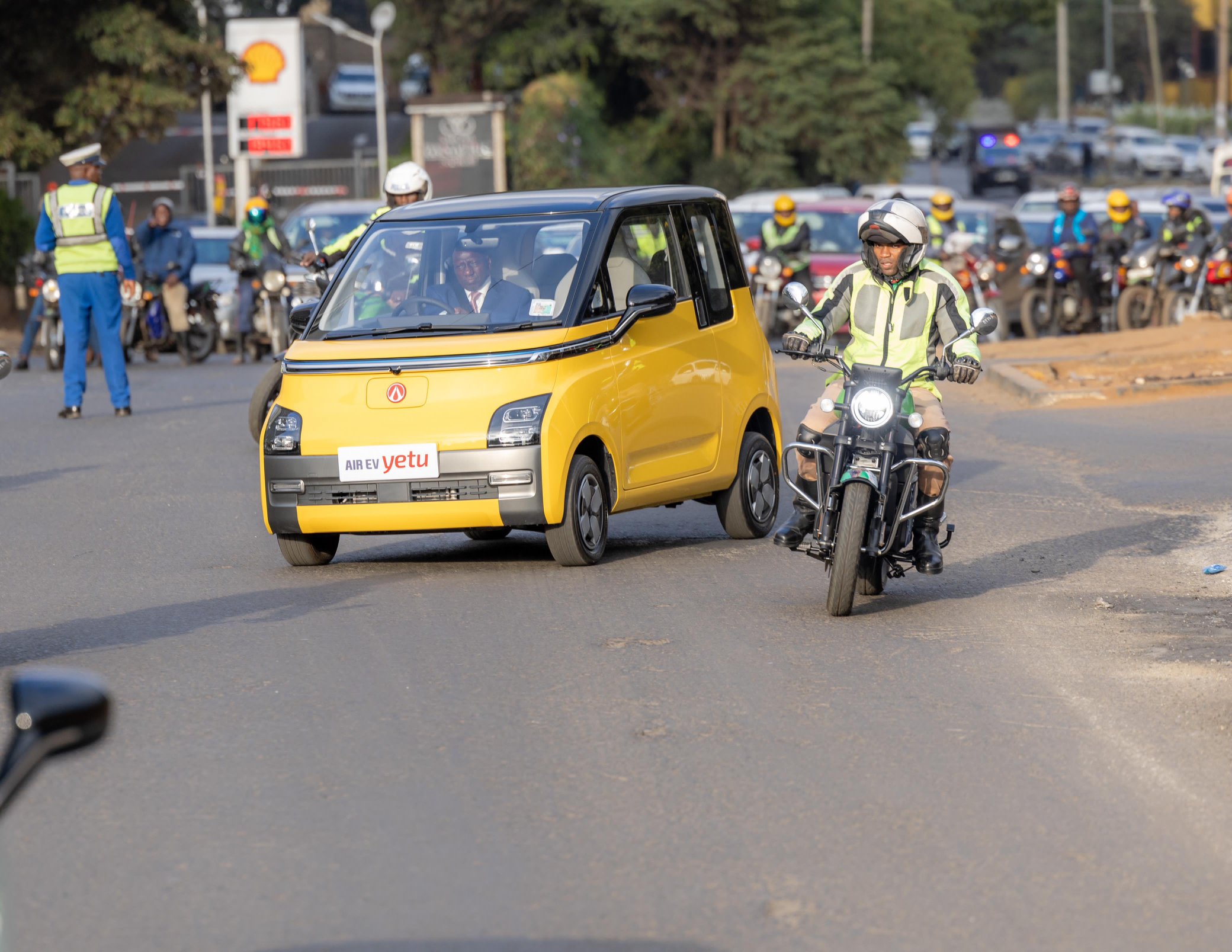 President William Ruto (in yellow car) drives himself in an EV on September 3, 2023 oh is way to attend the African Climate Summit at the KICC.