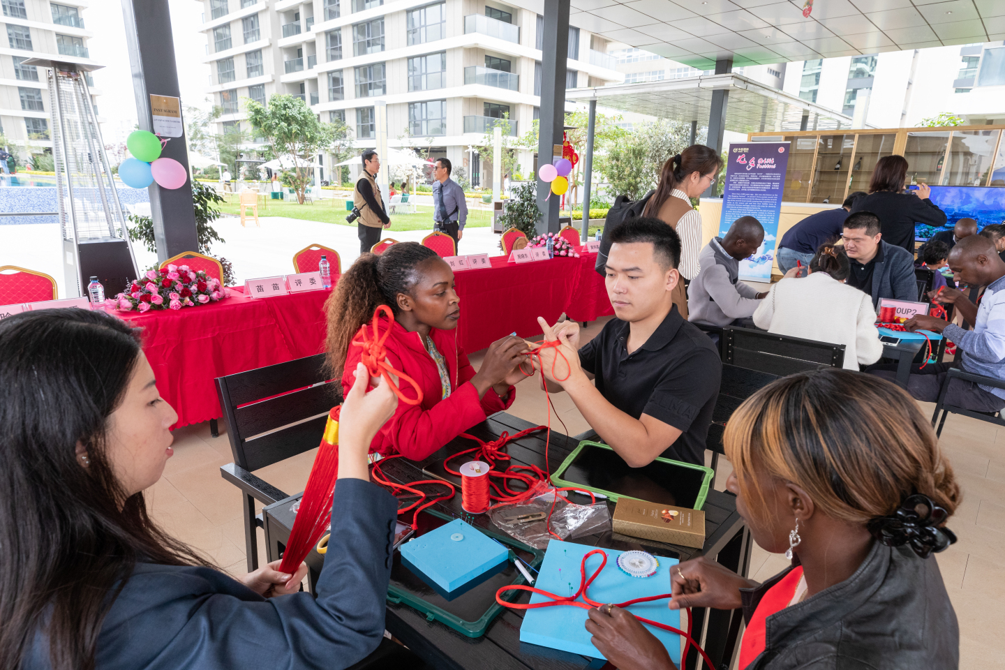 Chines and Kenyan employees interacting in a creative activity.