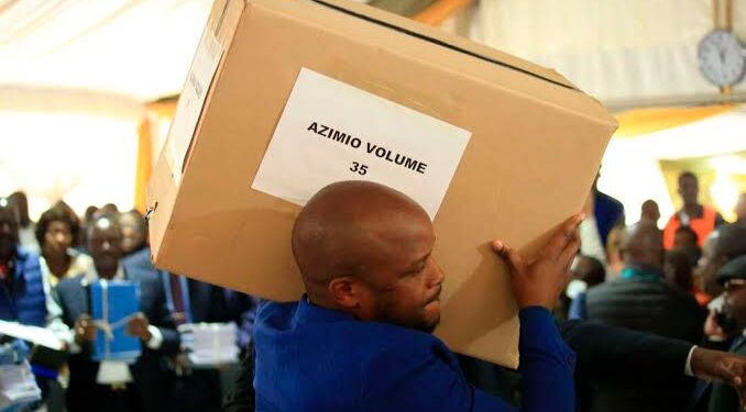 Lang'ata MP Felix Odiwuor carries a box containing evidence documents during the Azimio presidential election petition in August 2022.