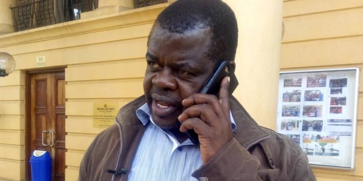 An undated photo of Busia Senator Okiyah Omtatah speaks on phone at the Milimani Law Courts in Nairobi.