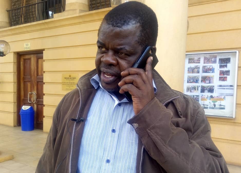 An undated photo of Busia Senator Okiyah Omtatah speaks on phone at the Milimani Law Courts in Nairobi. 
