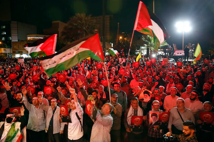 Iranians wave Palestinian flags during a celebration of the Hamas attack against Israel in Tehran.
