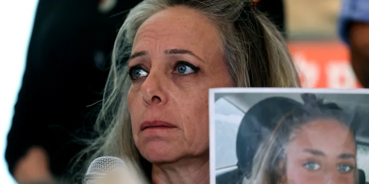 Keren Shem, the mother of hostage Mia Shem, holds a photograph of her daughter as she speaks to the press in Tel Aviv on Oct. 17, 2023.