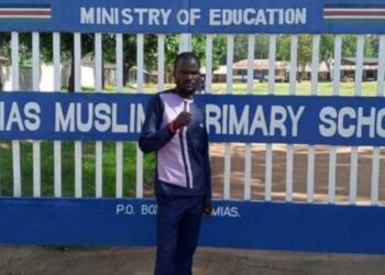 Famous political enthuathiast Nuru Okanga poses for a photo outside the Mumias Muslim Primary School in Kakamega.
