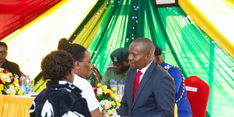 CS Kithure Kindiki consoling family members who lost their loved ones in the line of duty during the Commemaration Service