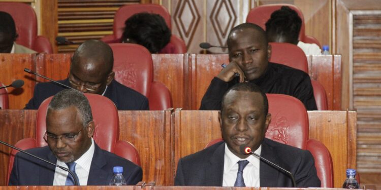Former Treasury Cabinet Secretary Henry Rotich (right) appears before a parliamentary committee in 2017.