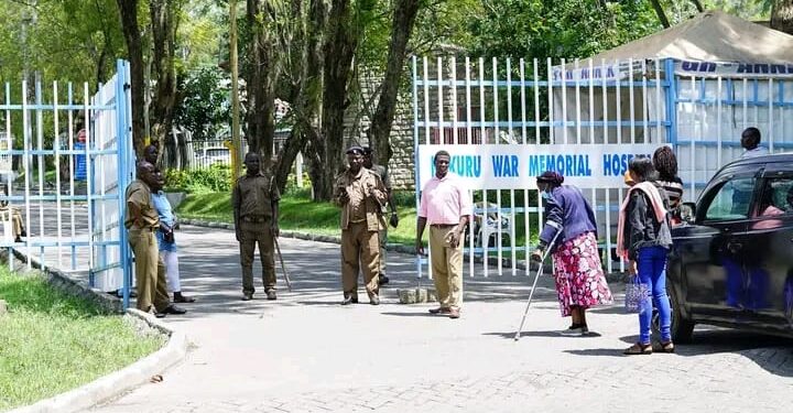 Patients and members of the public stand stranded at the entrance of the Nakuru War Memorial Hospital in Nakuru County. 