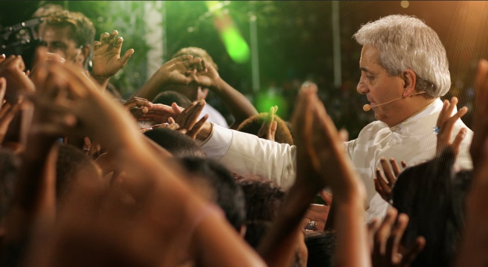 Benny Hinn greets a crow in one of his crusades. 