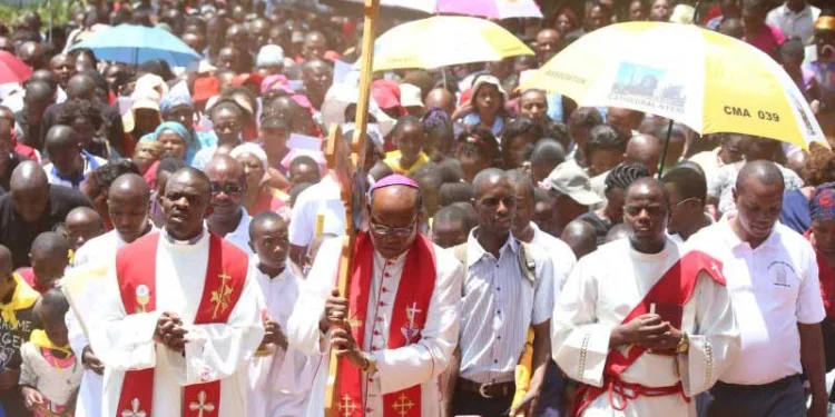 Archbishop Antony Muheria carries a cross as he leads believers in a past Easter celebrations. PHOTO/Courtesy.