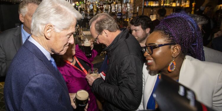 Former US President Bill Clinton speaking with Derry and Strabane District Councillor Lilian Seenoi-Barr. PHOTO/ Courtesy