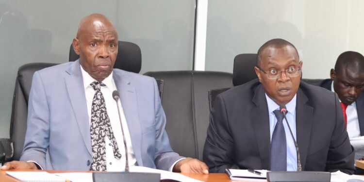 KNEC CEO Dr David Njegere (right) and Education CS Ezekiel Machogu appearing before the National Assembly Education Committee on April 9, 2024. PHOTO/Parliament.