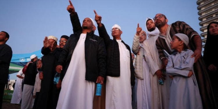 Muslims gesture as they await the sighting of the crescent moon that marks the end of the holy month of Ramadan. PHOTO/ Courtesy