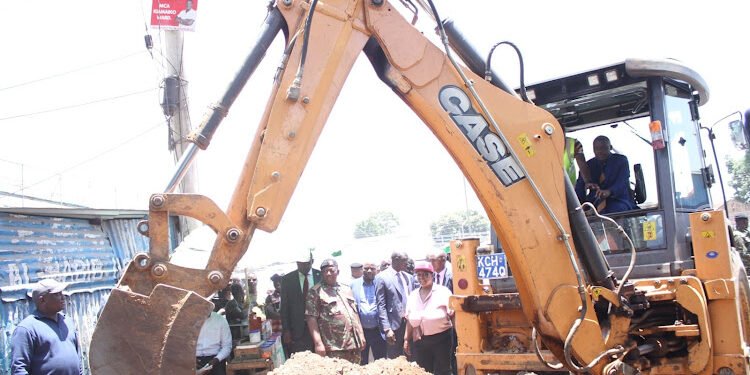 Water and Sanitation PS Paul Rono tries his hand on an excavator during a crackdown on illegal water connections at Kiamaiko in Nairobi on March 6, 2023. PHOTO/ Paul Rono