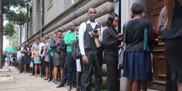 past photo of candidates lining up for a job interview. photo/NMG
