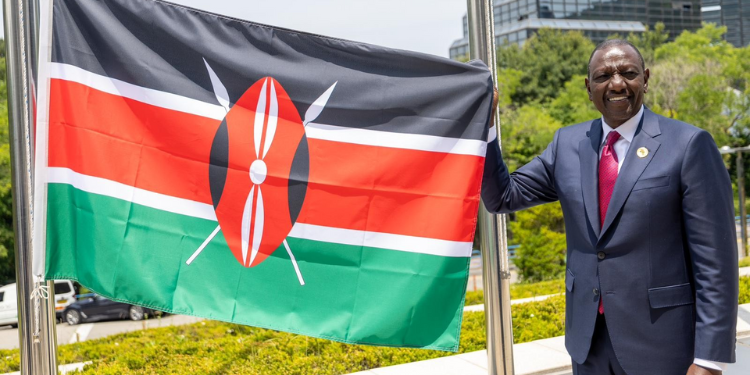 President Ruto holding Kenya's flag. Photo/President Ruto(X)