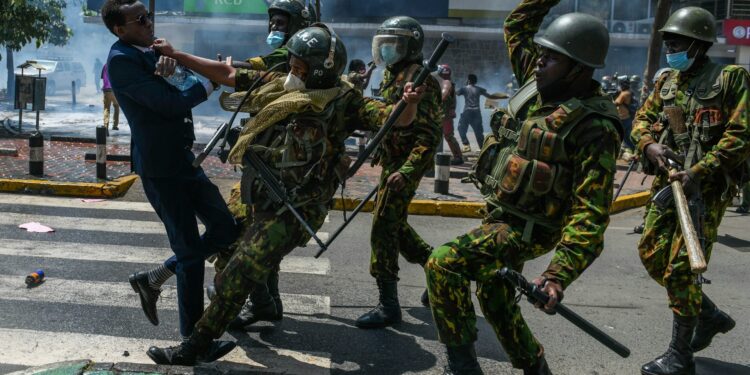 Kenyan police officers manhandle a protestor on June 25, 2024. Gerald Anderson/Anadolu via Getty Images